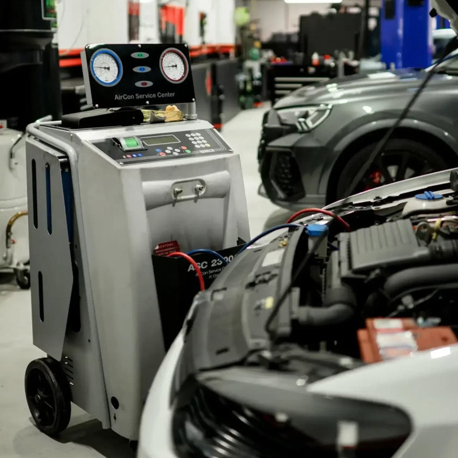 Technician inspecting an air-conditioning system on a European car